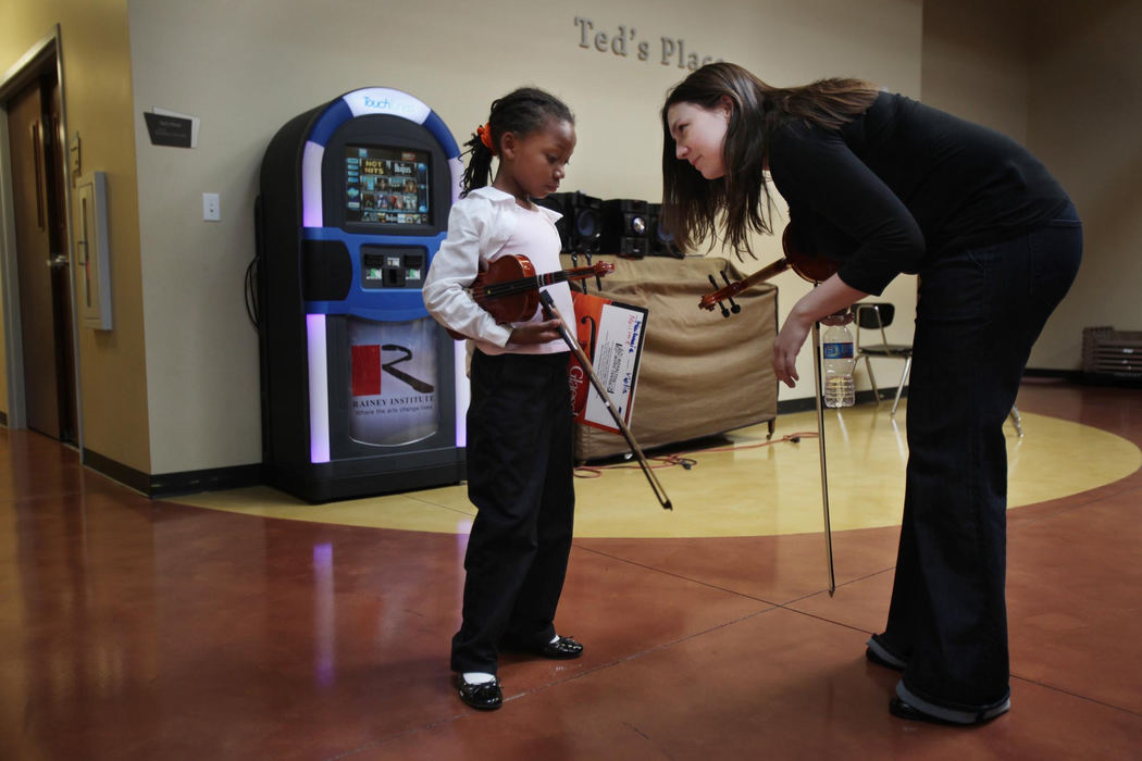 First place, Photographer of the Year - Large Market - Gus Chan / The Plain DealerCourntey Bonifant, a teacher, with El Sistema @ Rainey, pulls MaiLonnie Walton out of the group to talk with her.  Walton had been inattentive and disruptive to the other students so Bonifant took her aside to get her to refocus on her music.