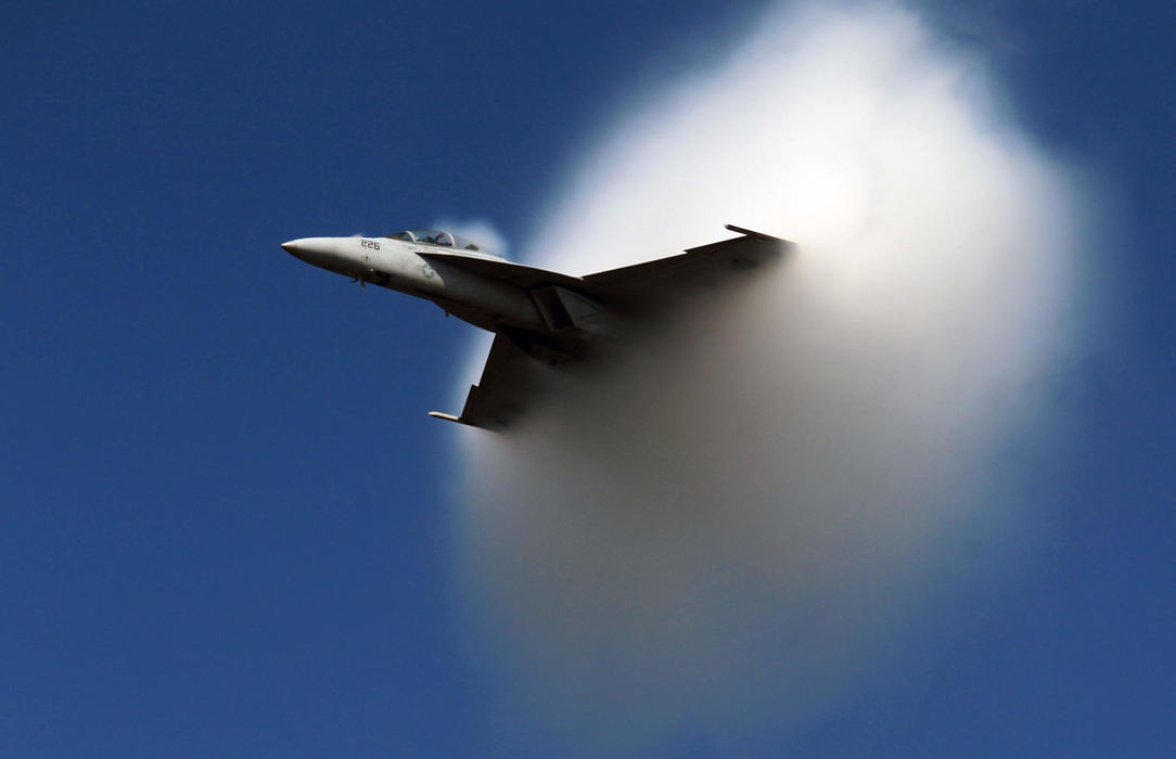 First place, Photographer of the Year - Large Market - Gus Chan / The Plain DealerA U.S. Navy F/A-18 breaks out of a visible condensation cloud at the Cleveland International Air Show on Sept. 3, 2012.  The cloud phenomenon occurs at subsonic speeds under certain atmospheric conditions.   