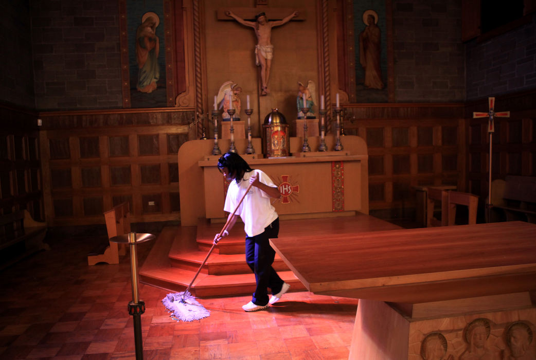 First place, Photographer of the Year - Large Market - Gus Chan / The Plain DealerAntoinette Polk, who works for A&V Cleaning, mops the altar of St. Barbara Catholic Church in preparation for it's reopening.  St. Barbara was ordered reopened by the Vatican after Bishop Richard Lennon closed it during the Catholic Church downsizing. 
