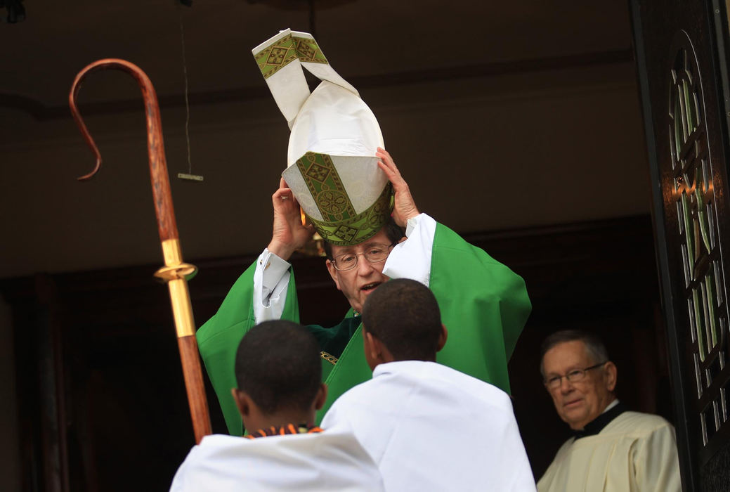 First place, Photographer of the Year - Large Market - Gus Chan / The Plain DealerBishop Richard Lennon puts on his mitre before the processional at St. Adalbert Catholic Church.  Bishop Richard Lennon installed Fr. Gary Chmura as pastor of St. Adalbert during morning mass.  
