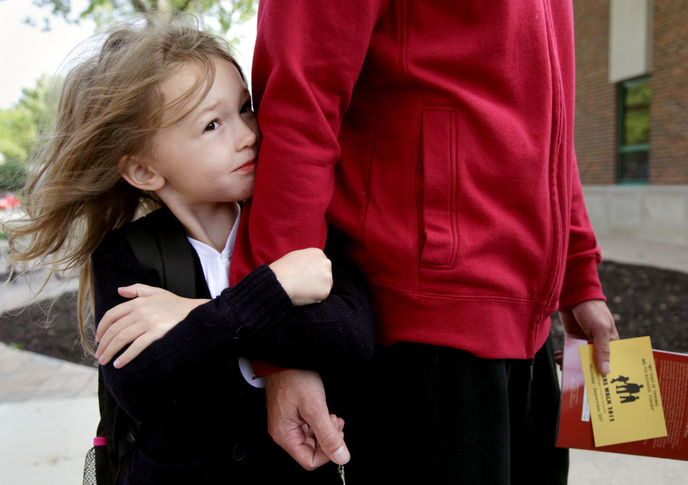 Third place, Photographer of the Year - Large Market - Marvin Fong / The Plain DealerSerena Hert, 5,  embraces the right arm of her stepfather Jessie Nicholson as they walk to Louisa May Alcott school in Cleveland,OH.  They were participating in "Fathers walk", where men involved in the lives of their kids, took them to school.  