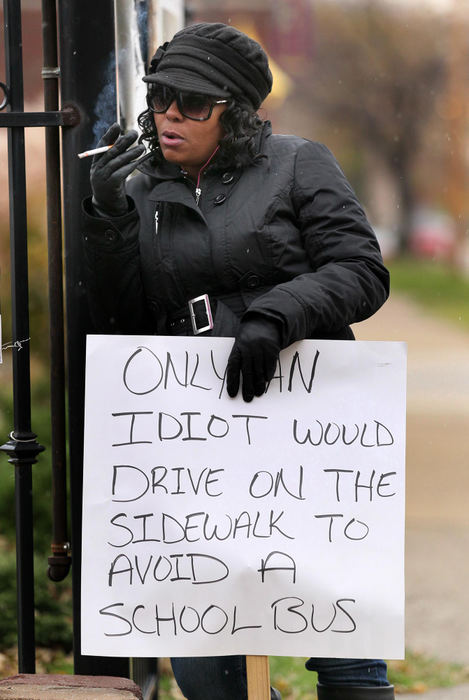 Third place, Photographer of the Year - Large Market - Marvin Fong / The Plain DealerShena Hardin was ordered by a Cleveland judge to stand with a sign that reads:  "Only an idiot would drive on the sidewalk to avoid a school bus.  Hardin's license was suspended for 30 days and ordered to pay a $250 fine for failing to stop and using a sidewalk to pass the bus. 