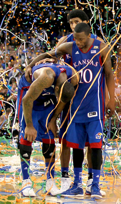 Third place, Photographer of the Year - Large Market - Marvin Fong / The Plain DealerDejected Kansas Jayhawks , Thomas Robinson (0), Tyshawn Taylor (10), and Kevin Young (40)  are stunned after losing to Kentucky at the NCAA Final Four Championship game in New Orleans, LA.  