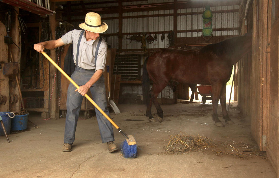 Third place, Photographer of the Year - Large Market - Marvin Fong / The Plain DealerEli Shrock sweeps the barn owned by his grandfather Sam Mullet in Bergholz, OH.  His father Emmanuel Shrock was sentenced to 5 years in prison and Mullet received 15 years for their roles in beard and hair cutting attacks.  