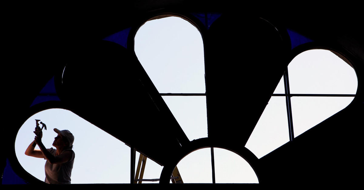 First place, Photographer of the Year - Large Market - Gus Chan / The Plain DealerKaren Cheshier, of Azure Stained Glass, cleans the frame of the stained glass window at St. Timothy Missionary Baptist Church.  The window was being repaired from storm damage earlier in the year.  