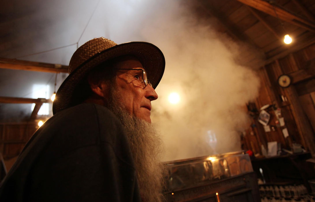 First place, Photographer of the Year - Large Market - Gus Chan / The Plain DealerJonas Gingrich waits in the Sperry Sugar House as sap is boiled to make maple syrup.  Gingrich has been making maple syrup for 43 years. 