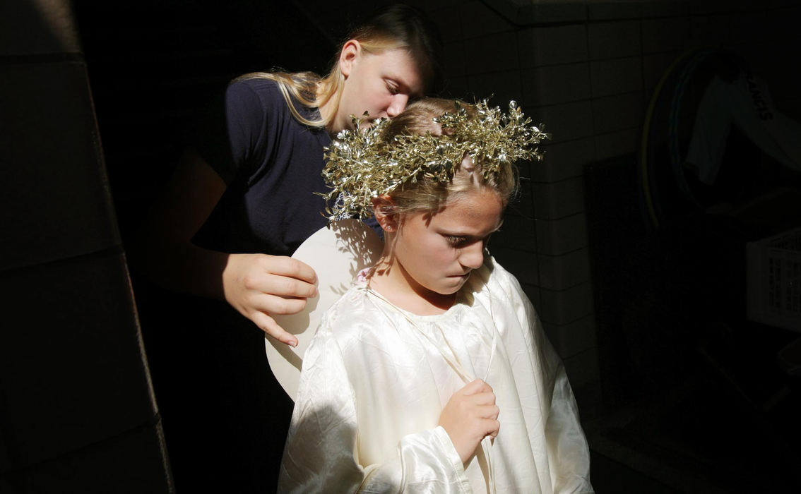 Award of Excellence, Photographer of the Year - Large Market - John Kuntz / The Plain DealerFrancesca Longano, 9, gets her wings fastened to her angel costume with the help of Betz Meluch before the Feast of The Assumption procession August 15, 2012 in the Little Italy neighborhood in Cleveland.  Francesca will ride on the float with the Virgin Mother Mary icon float.    