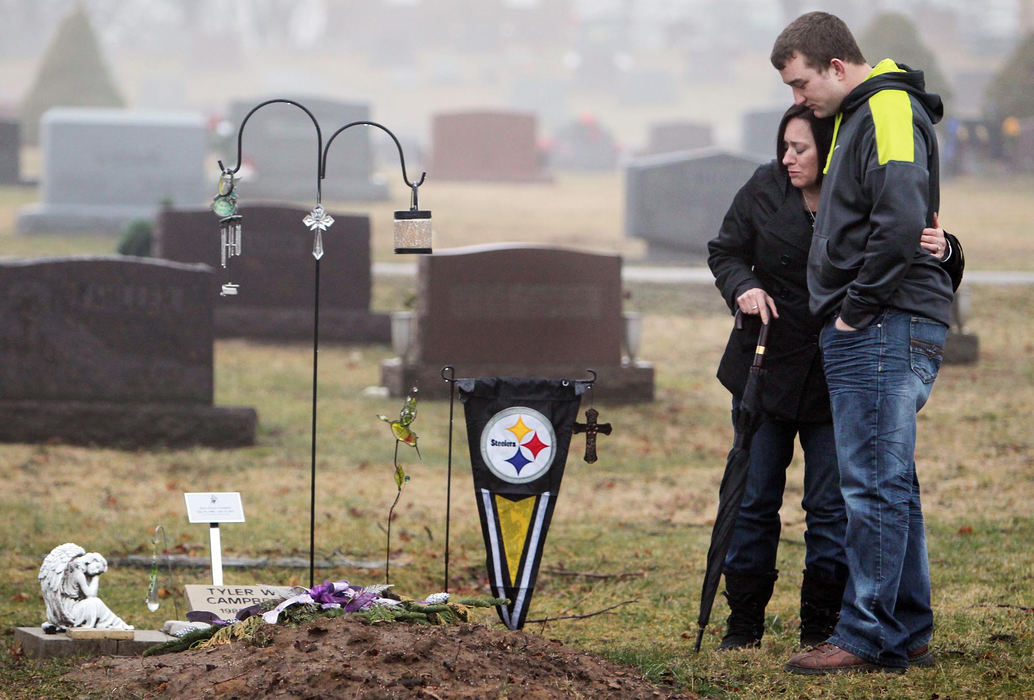 Award of Excellence, Photographer of the Year - Large Market - John Kuntz / The Plain DealerBen Christy and Christy Campbell hug as they visit the gravesite Christy Campbell's oldest son Tyler January 26, 2012 at the Violet Cememtery in Pickerington, Ohio.  Tyler died in July of 2012 from a heroin overdose.  Ben Christy was one of Tyler's best friends and is joining the Campbell family's nonprofit foundation, Tyler's Light, designed to equip youths in Pickerington and throughout Fairfield County with the resources to help them choose a drug-free life. 