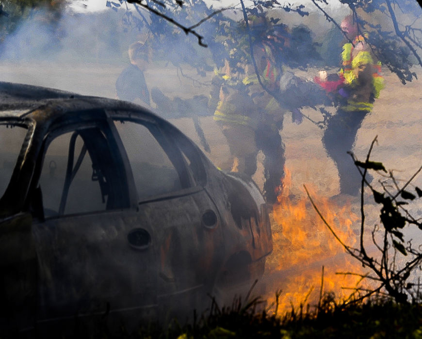 First place, Photographer of the Year - Small Market - Bill Lackey / Springfield News-SunA crash victim is seen through the rippling heat rising off the burning car they escaped from as firefighters carry them to a medic unit after the car they were in struck a tree along Fletcher-Chapel Road in Harmony Township and burst into flames. The driver and passenger were both transported to the hospital with non-life threatening injuries. 