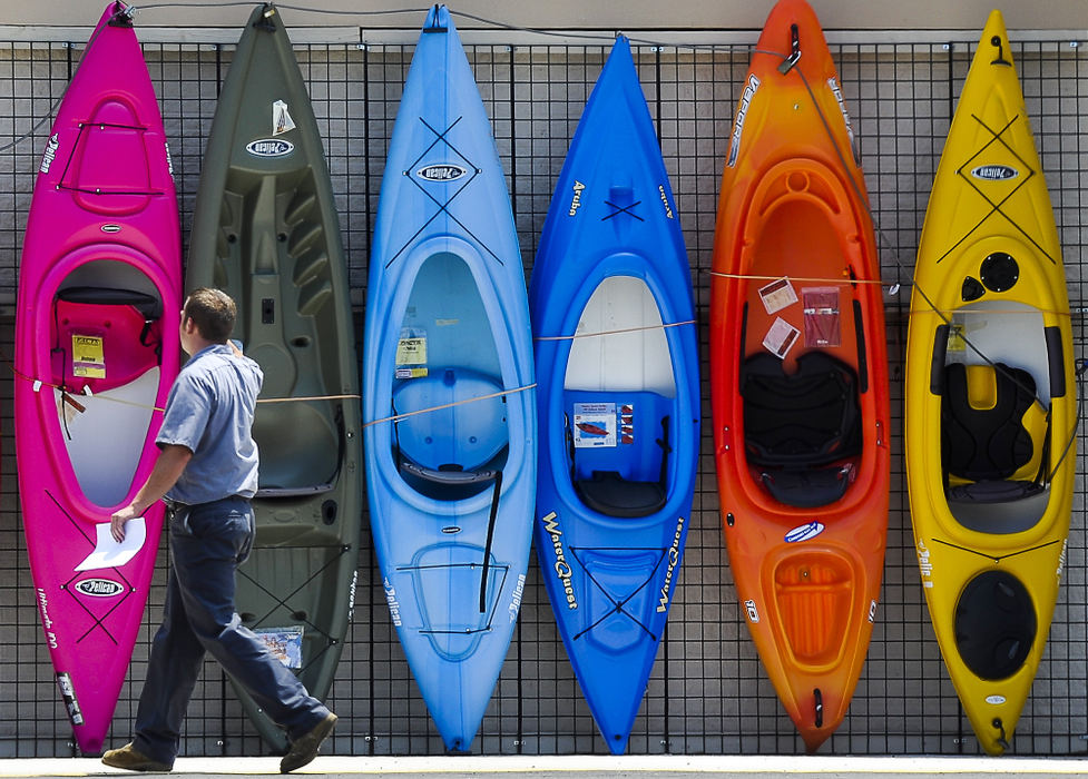 First place, Photographer of the Year - Small Market - Bill Lackey / Springfield News-SunA pedestrian walks past a row of brightly colored kayaks on display outside Dunham's Sporting Goods in Springfield as he enters into the store. 