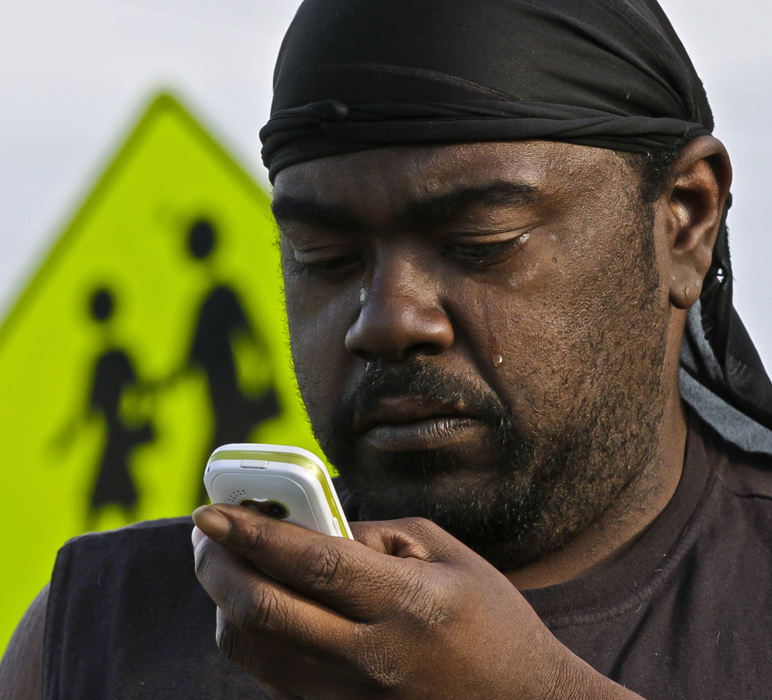 Second place, Photographer of the Year - Small Market - Barbara J. Perenic / Springfield News-SunThrough tears, Richard White calls family members after the car he was driving hit two young children who were reportedly both riding on the same bicycle late Wednesday afternoon.