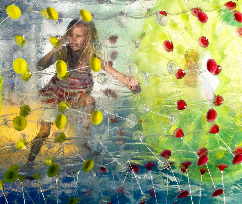 Second place, Photographer of the Year - Small Market - Barbara J. Perenic / Springfield News-SunTehlor Stant, 8, rolls around a shallow pool in a giant inflatable ball on the midway.
