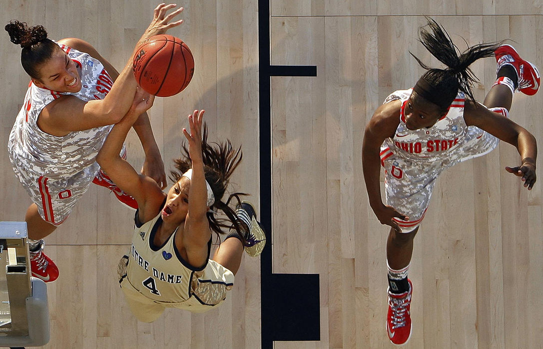 Award of Excellence, Sports Action - Kyle Robertson / The Columbus DispatchOhio State Buckeyes center Ashley Adams blocks the shot of Notre Dame Fighting Irish guard Skylar Diggins during the 1st half of the Carrier Classic on the Yorktown Carrier in Charleston, S.C.