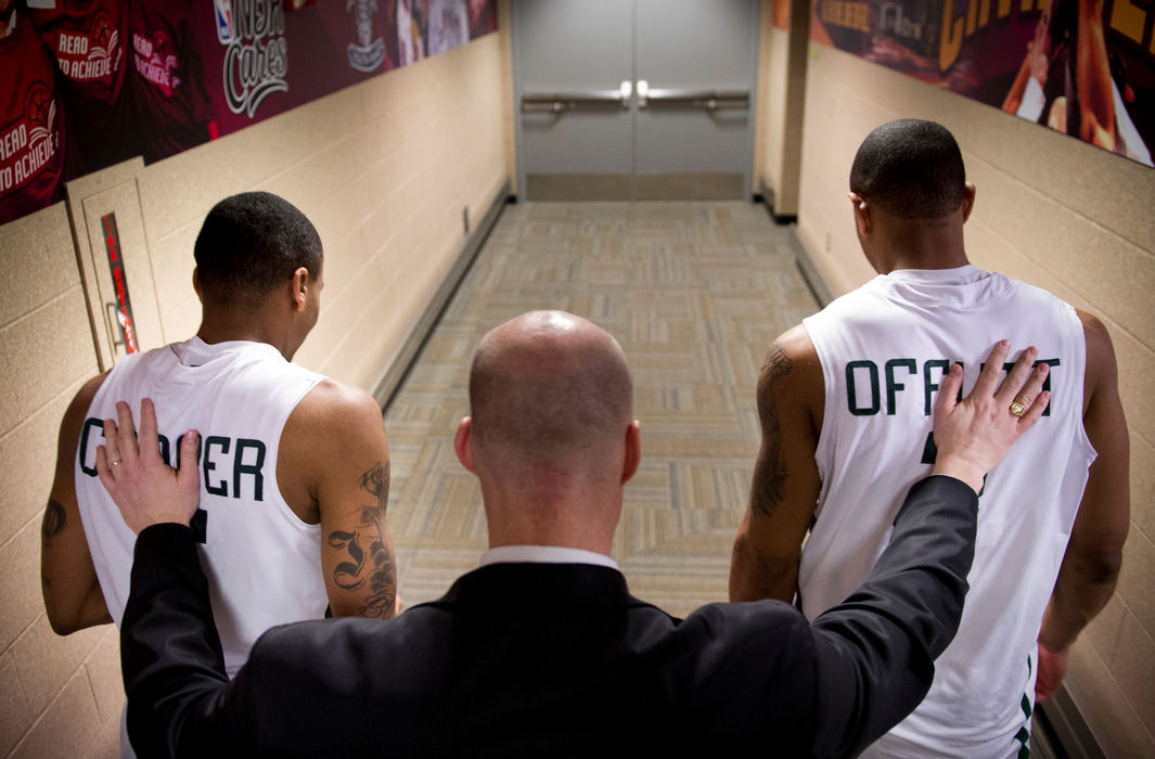 Second place, Sports Feature - Joel Hawksley / Ohio UniversityOhio head coach John Groce embraces D.J. Cooper and Walter Offutt as they head to the press conference after their 77-74 win over Buffalo for a spot in the MAC championship at Quicken Loans Arena in Cleveland, Ohio.