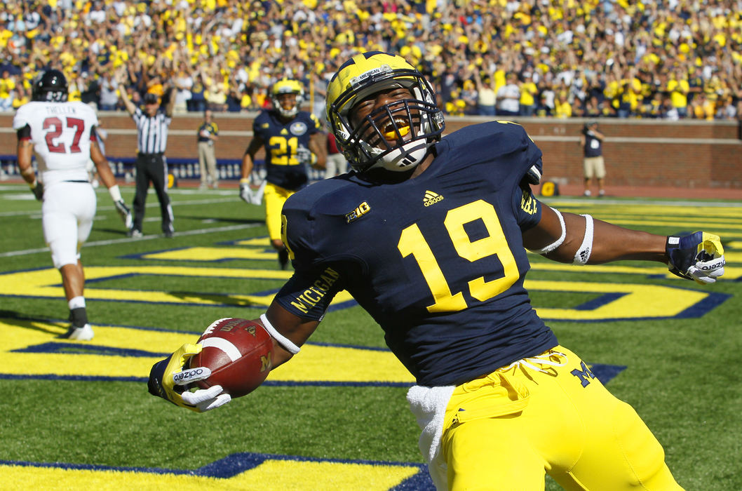 Award of Excellence, Sports Feature - Andy Morrison / The (Toledo) BladeUniversity of Michigan player Devin Funchess, 19, celebrates his first quarter touchdown against the University of Massachusetts at Michigan Stadium in Ann Arbor.
