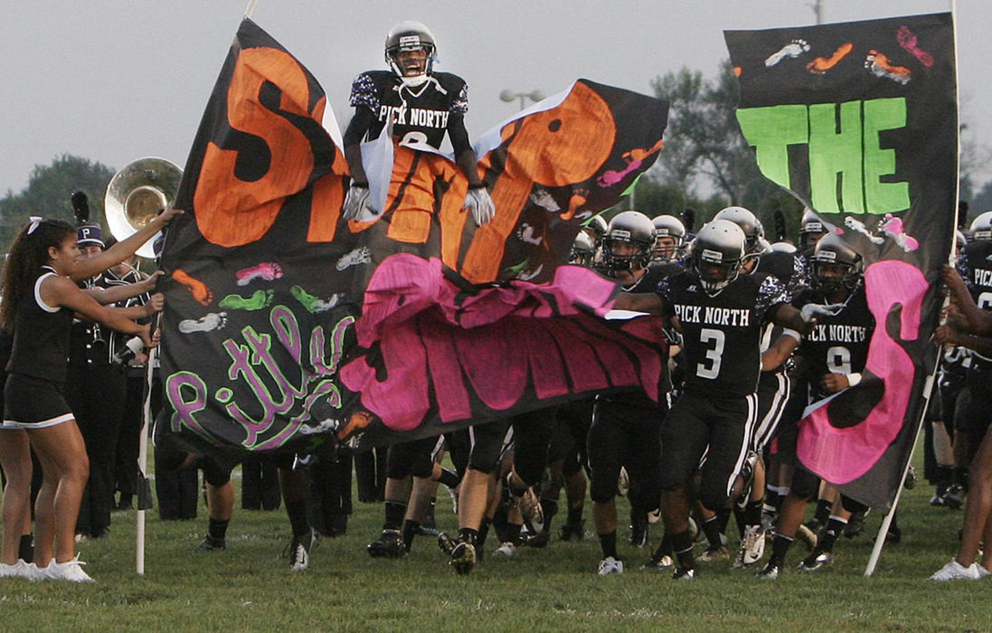 Award of Excellence, Sports Feature - Tim Revell / ThisWeek NewspapersThe Pickerington North Panthers take to the field in their game with Fremont Ross. Jamie Hence (8) of the Panthers is in the air. 