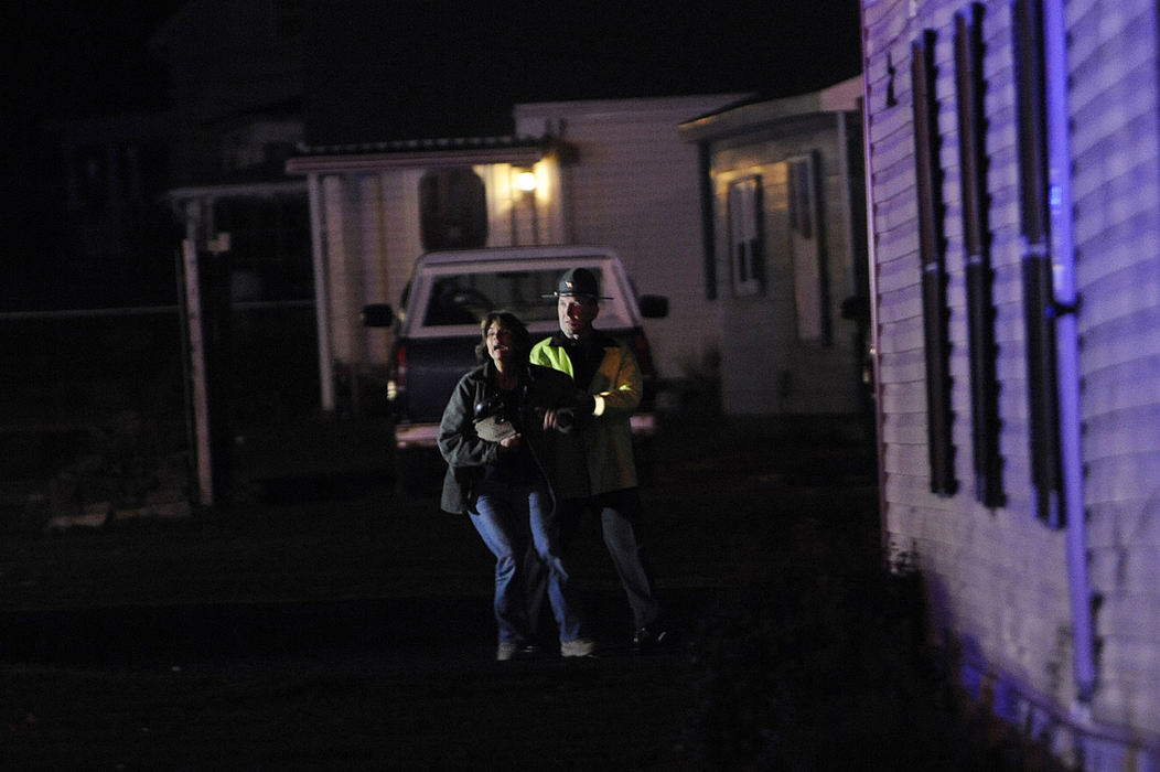 Award of Excellence, Spot News (Under 80,000) - Brent Lewis / Chillicothe GazetteDaughter of Donald Hatfield cries out while being pulled into the family's home after her father was struck and killed by across the street from his home on Tuesday, November 20, 2012 on the 14000 block of Highway 772 outside of Chillicothe.