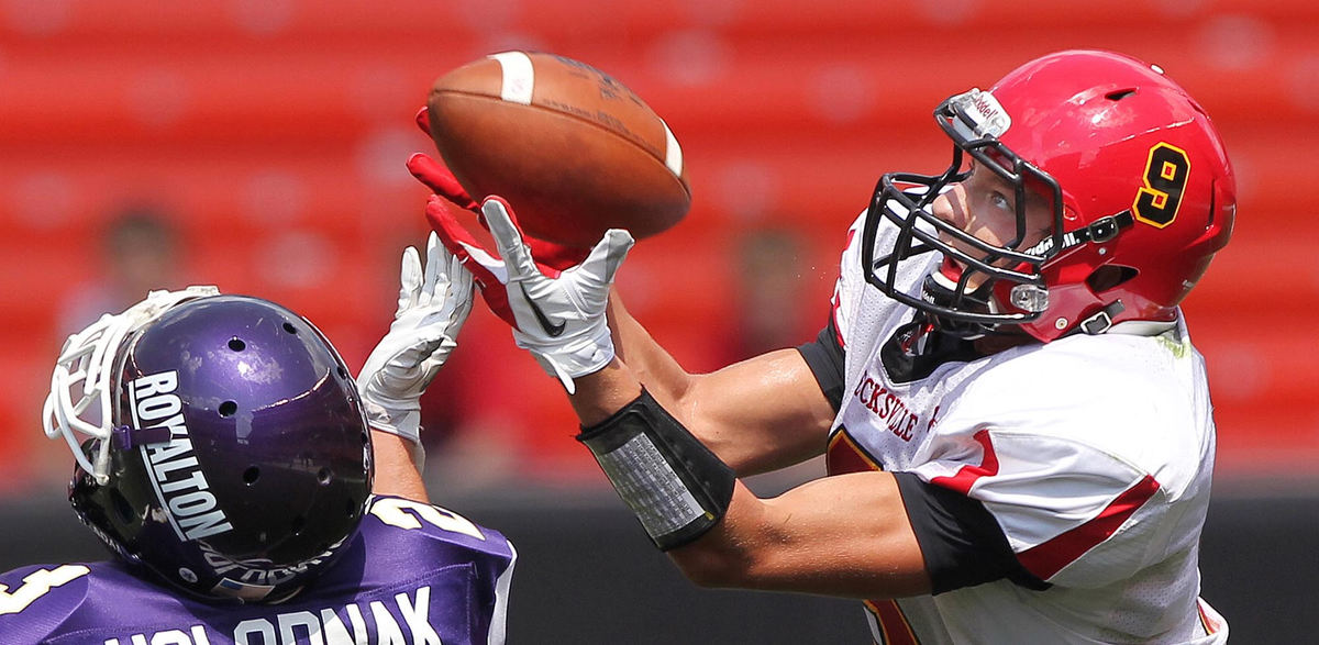 Award of Excellence, Sports Portfolio - John Kuntz / The Plain DealerBrecksville-Broadview Heights receiver Tim Tupa hauls in a first down catch in the first half just out of reach of North Royalton's Jake Holodnak August 25, 2012 during the annual high school Charity Game at Cleveland Browns Stadium.  North Royalton went on to win the game, 54-42. 