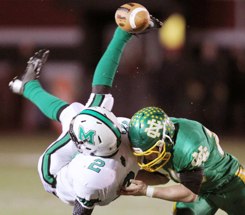 Award of Excellence, Sports Portfolio - John Kuntz / The Plain DealerMogadore receiver Hunter Van Camp is flipped up in the air as he is hit by Newark Catholic's Patrick Oehlman on an incomplete pass in the first quarter November 23, 2012 at Woody Hayes Quaker Stadium in New Philadelphia during Division VI semifinal game. 