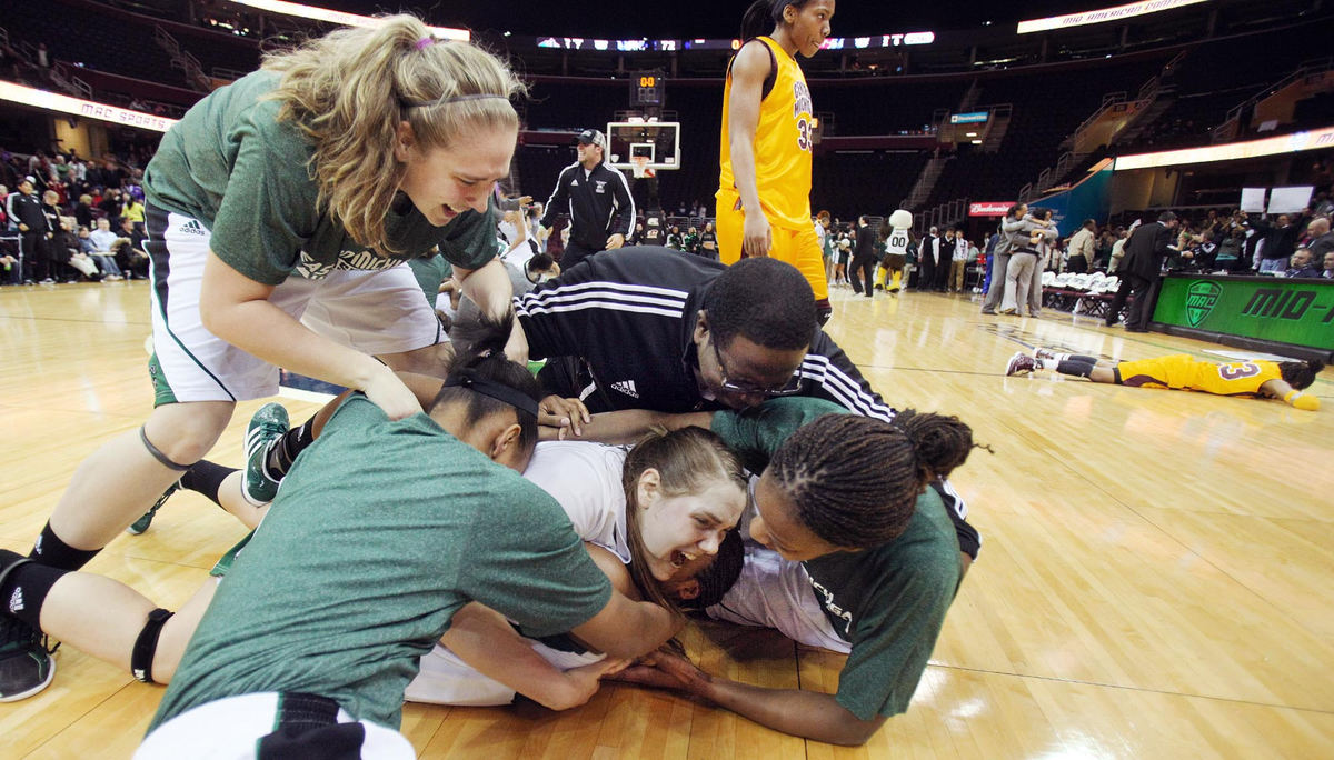 Award of Excellence, Sports Portfolio - John Kuntz / The Plain DealerEastern Michigan players pile on Paige Redditt after she scored the winning basket with a few seconds left on the clock against Centeral Michigan during the Mid-American Conference championship game March 10, 2012 at Quicken Loans Arena. 