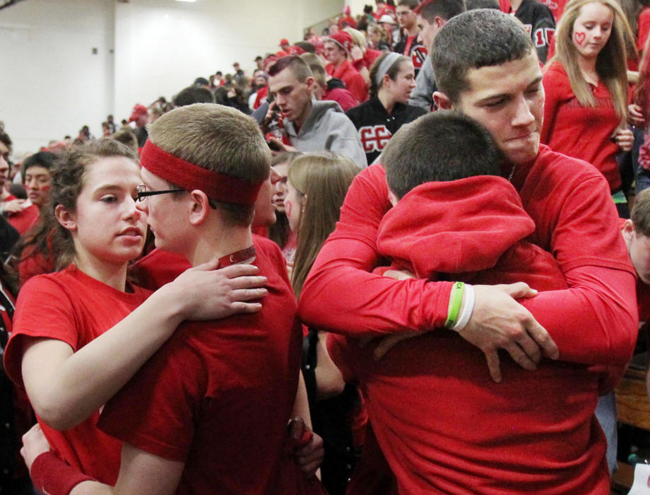 Award of Excellence, Sports Portfolio - John Kuntz / The Plain DealerChardon High School students hug after their Hilltoppers boys basketball team beat Madison High with mixed emotions March 1, 2012 during a Division I sectional semifinal game at Euclid High School.  