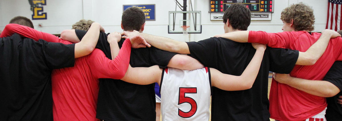 Award of Excellence, Sports Portfolio - John Kuntz / The Plain DealerChardon High School basketball players are arm-in-arm between Madison High School players who chose to wear black Chardon shirtsMarch 1, 2012 in honor of the shooting tradegy February 27 before the start of their Division I sectional semifinal game at Euclid High School. 