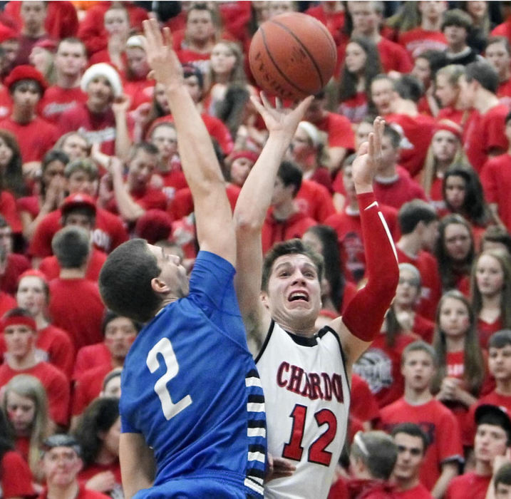 Award of Excellence, Sports Portfolio - John Kuntz / The Plain DealerChardon's Nick Ruckel takes a shot on Madison's Stephon Ortiz during the first half against the background of the Hilltoppers student fans March 1, 2012 during a Division I sectional semifinal game at Euclid High School.  