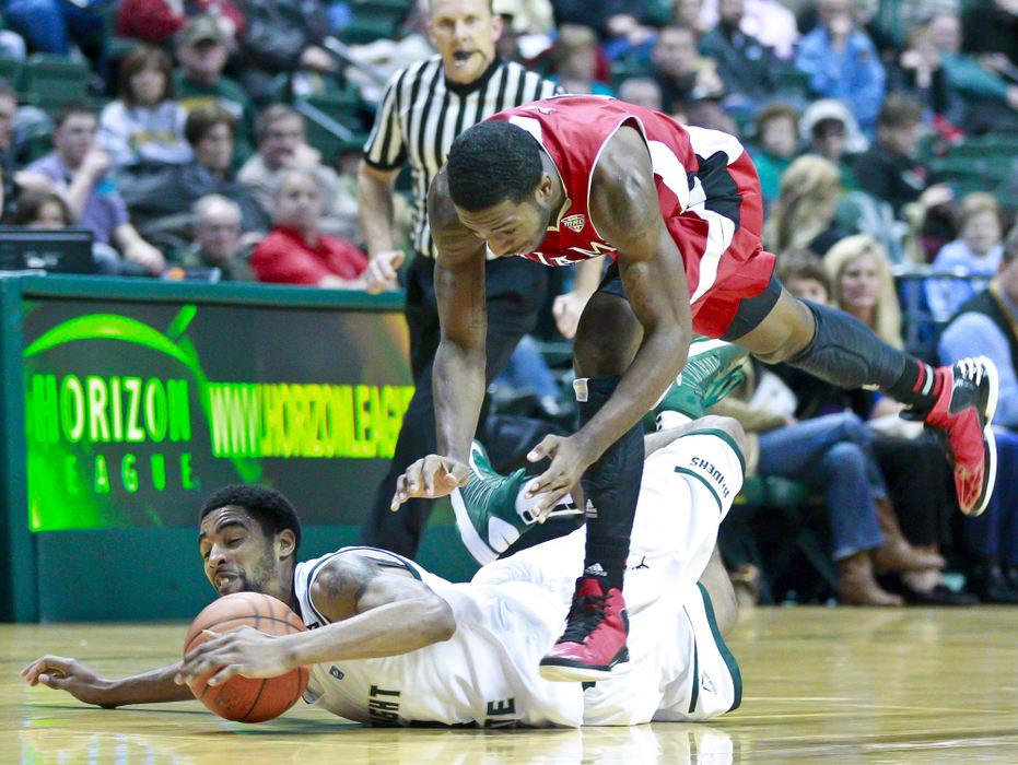 Award of Excellence, Sports Portfolio - Barbara J. Perenic / Springfield News-SunJerran Young (4) of Wright State and Geovonie McKnight (0) of Miami chase a loose ball during Wednesday's game at the  Nutter Center.