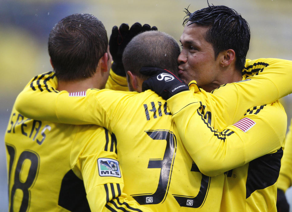 Award of Excellence, Sports Portfolio - Eamon Queeney / The Columbus DispatchColumbus forward Jairo Arrieta (25) gives fellow forward Federico Higuain (33) a kiss as they celebrate Higuain's goal with Ben Speas (18) in the first half of the Columbus Crew's last game of the season against Toronto FC in the pouring rain at Crew Stadium, Sunday afternoon, October 28, 2012. Higuain later scored a second goal in the second half to seal the Columbus win. The Columbus Crew defeated the Toronto FC 2 - 1 for the third time this season, which included a  2 - 1 win on August 22 and a 1 - 0 win on March 31. 