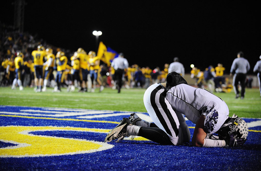 Award of Excellence, Sports Portfolio - Eamon Queeney / The Columbus DispatchAs Moeller celebrates in the background, Pickerington North senior Jake Butt (1) reacts after a missed run to the end zone cost them the game in the fourth quarter of the OHSAA Division I state semifinal football game at Dayton Welcome Stadium, Saturday night, November 24, 2012. The Archbishop Moeller Fighting Crusaders defeated the Pickerington North Panthers 26 - 21 to move on to the state championship game. 