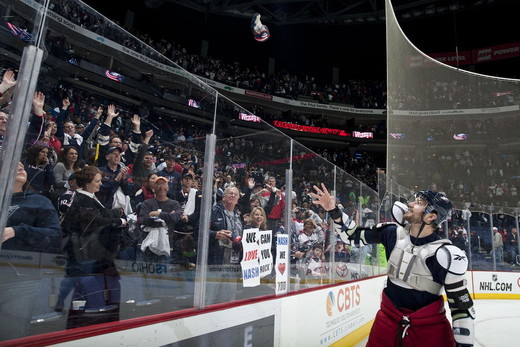 Award of Excellence, Sports Portfolio - Eamon Queeney / The Columbus DispatchColumbus Blue Jackets right wing Rick Nash (61) throws his gloves into the crowd for what could be the last time as a Blue Jacket after the Columbus Blue Jackets win over the New York Islanders, Saturday evening, April 7, 2012. The Blue Jackets defeated the New York Islanders 7 - 3 in their last game of the season at Nationwide Arena in Columbus. 