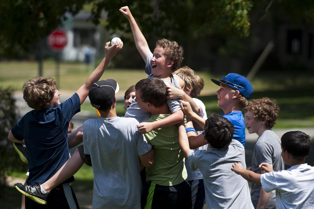 Award of Excellence, Sports Portfolio - Eamon Queeney / The Columbus DispatchFist held high, Brody Stranges, 12, is congratulated by his friends after his 5th seeded team beat the 4th seeded team in a quarter final elimination round during the Sherwood Wiffleball World Series, Saturday afternoon, June 23, 2012. Brody would later be voted as the championship's most valuable player. Eight, two-boy teams, all of Bexley, battled it out in their own devised wiffleball championship on the front lawn of 14-year-old commissioner Matt Plank for a trophy, $160 in prize money ($10 paid in by each player) and bragging rights for a whole year. Complete with elimination rounds, fierce fielding and past-the-bushes home runs, the boys all celebrated together when Peter Hayden, 13, and Jake Greenberg, 13, took home the title. 
