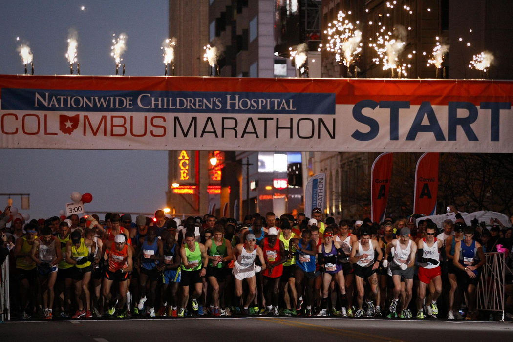 Award of Excellence, Sports Portfolio - Eamon Queeney / The Columbus DispatchFireworks explode and runners start their watches as they take the first step of the Columbus Marathon Sunday morning, October 21, 2012. The annual Columbus Marathon packed 18,000 runners and walkers into the full and half marathons that snaked through the city on a cool and foggy fall morning. This year the Nationwide Children's Hospital was named the title beneficiary and at each mile there was a "patient champion;" 26 children, each with a life-altering story of disease. 