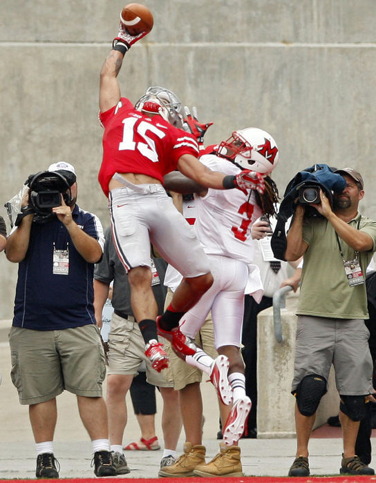 Award of Excellence, Sports Portfolio - Kyle Robertson / The Columbus DispatchOhio State Buckeyes wide receiver Devin Smith makes a one handed touchdown catch against Miami Redhawks cornerback Dayonne Nunley during the 2nd quarter of their NCAA College Football game at Ohio Stadium, September 1, 2012. 