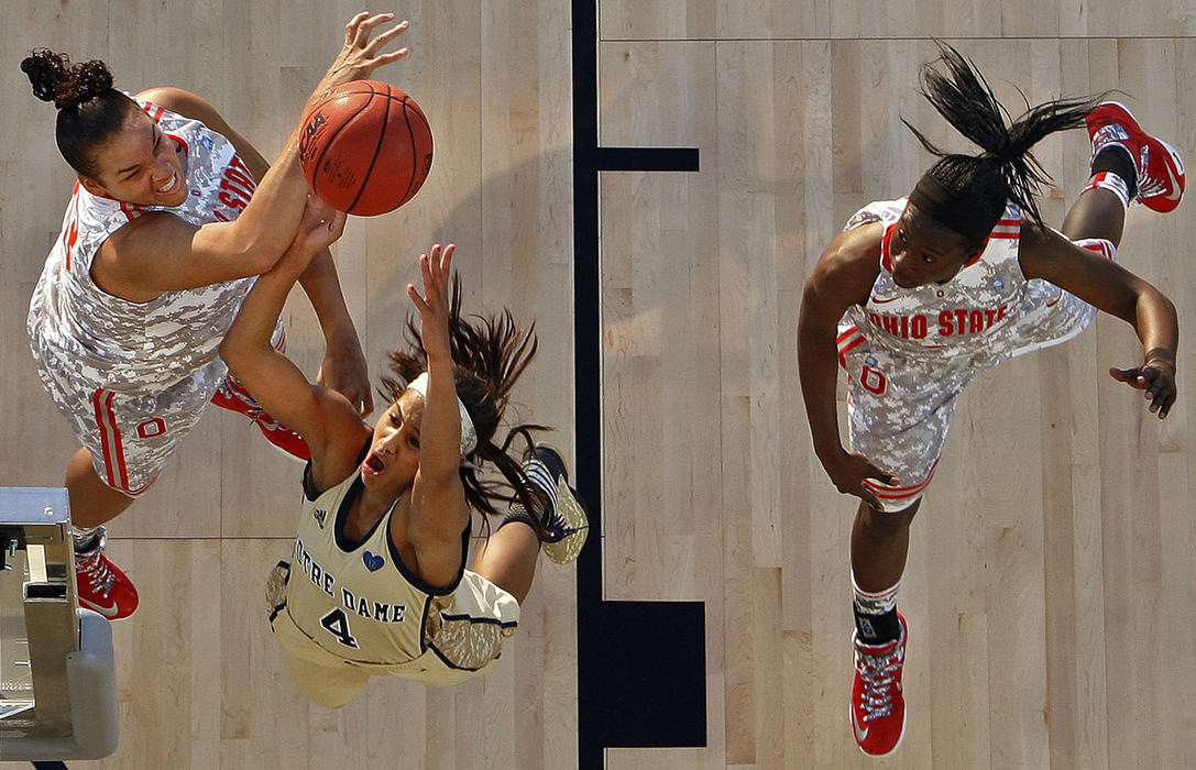 Award of Excellence, Sports Portfolio - Kyle Robertson / The Columbus DispatchOhio State Buckeyes center Ashley Adams blocks the shot of Notre Dame Fighting Irish guard Skylar Diggins during the 1st half of the Carrier Classic on the Yorktown Carrier in Charleston, S.C. November 9, 2012.  