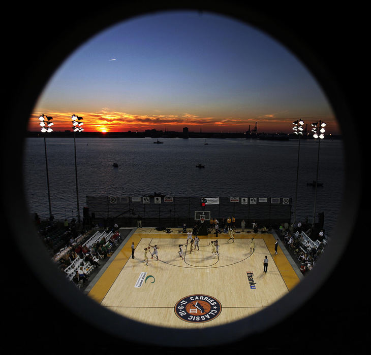 Award of Excellence, Sports Portfolio - Kyle Robertson / The Columbus DispatchOhio State Buckeyes take on Notre Dame Fighting Irish during the 2nd half of the Carrier Classic on the Yorktown Carrier in Charleston, S.C. November 9, 2012.  The photo is shot through a porthole on the the Yorktown Carrier. 