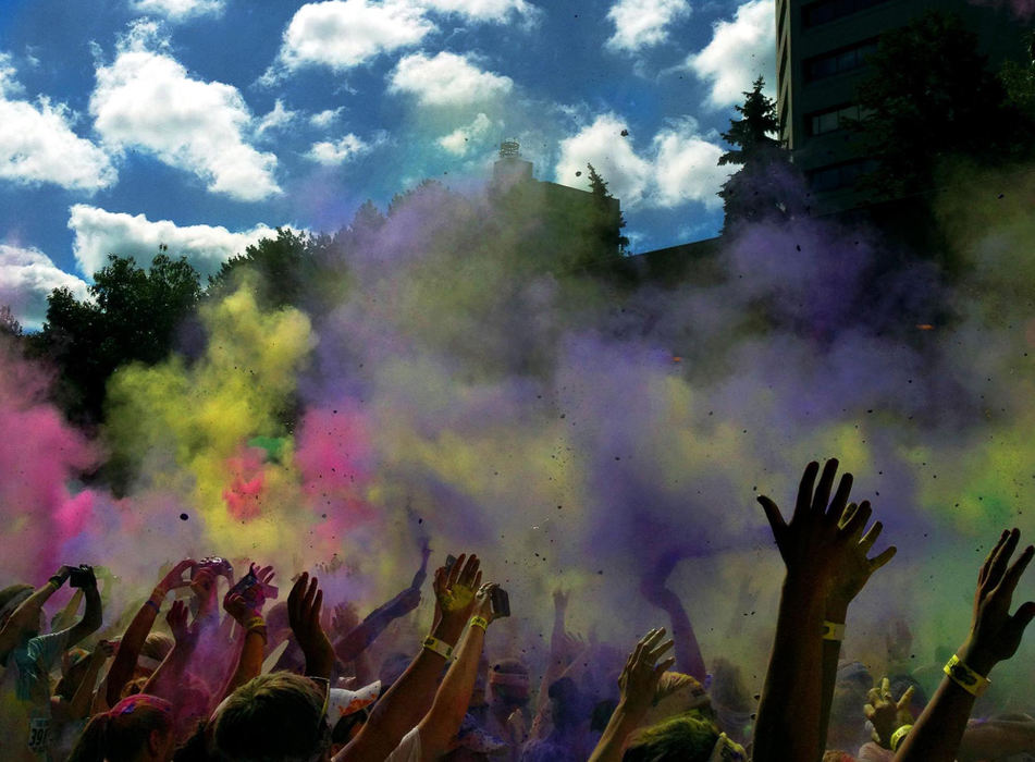 Award of Excellence, Sports Portfolio - Kyle Robertson / The Columbus DispatchThe Color Run participants toss up color chalk while celebrating the end of the 5K run on West Long Street in Columbus, July 21, 2012. Officials estimated that more than 12,000 people participated in the event, which featured runners passing through several color stations where they were doused with pink, blue, yellow and orange chalk. 