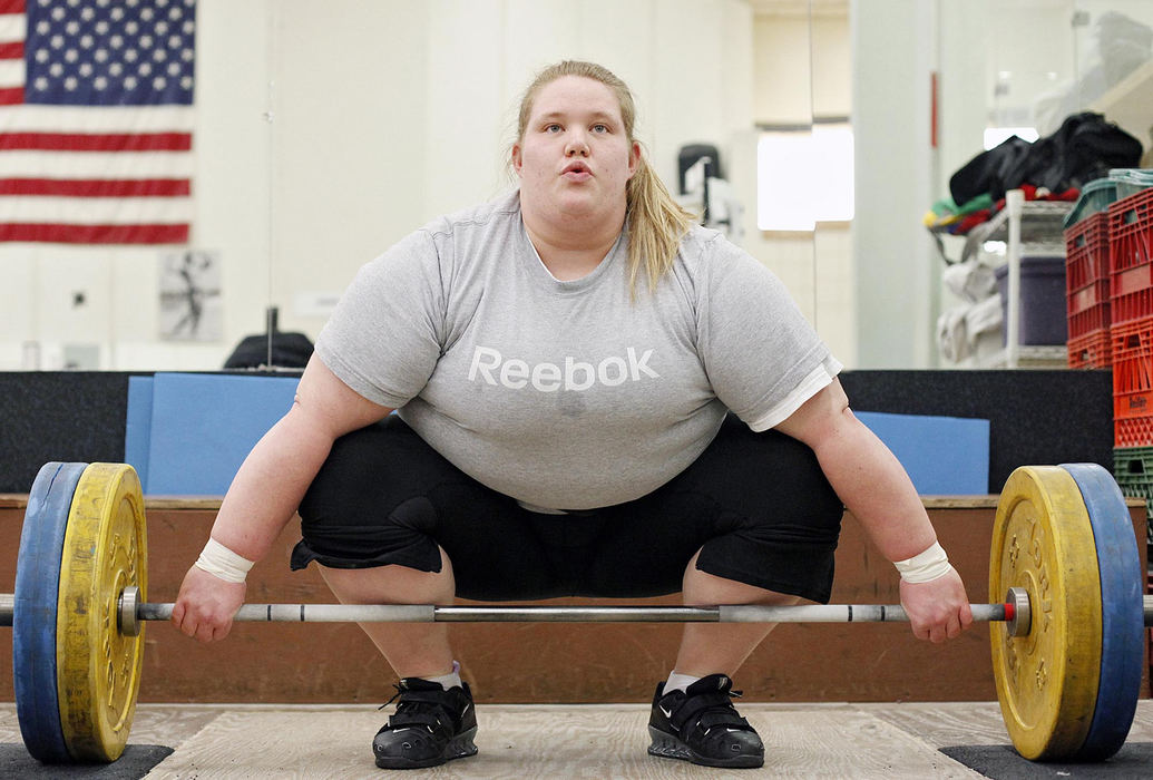 Award of Excellence, Sports Portfolio - Kyle Robertson / The Columbus DispatchHolley Mangold has always been a “big girl.”  Big enough to play on the offensive line of her high-school football team that made it to a state-championship game.  Now, Mangold hopes that her size, 5 foot 8 inches tall and 340 pounds, but, more importantly, her strength and skill can help her achieve a lifelong dream of competing in the Olympics.  Mangold the 22-year-old was one of 15 women invited to compete for two open spots on the U.S. team in the Olympic Team Trials for weightlifting.  Ranked second in the nation among women by USA Weightlifting, the Centerville native, now living and training in Columbus, is in a strong position to make it to the Summer Olympics in London.Holley Mangold prepares to snatch during a training session at the YMCA North in Columbus, February 20, 2012.  