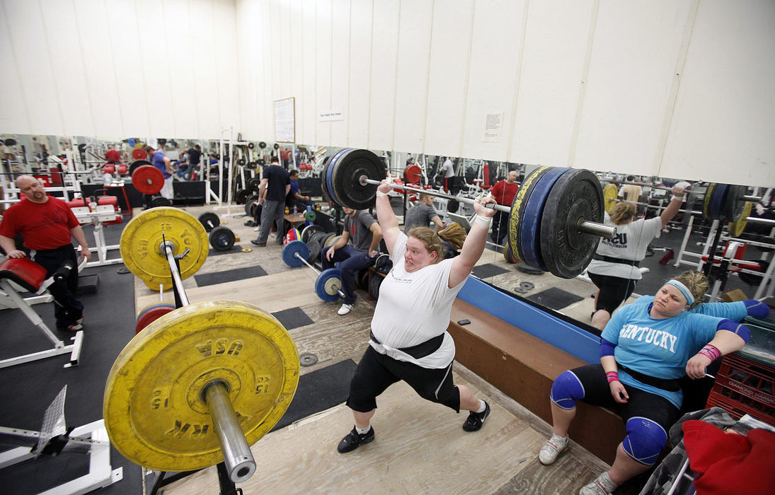 Award of Excellence, Sports Portfolio - Kyle Robertson / The Columbus DispatchHolley Mangold pulls the bar over her head during a snatch lift during a training session at the YMCA North in Columbus, February 20, 2012.   