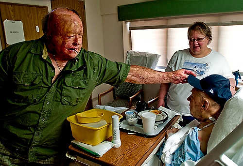 Second place, Student Photographer of the Year - Hannah Potes / Kent State UniversityKlavon places his father's favorite Detroit Tigers hat on his head during a visit to Allegiance Health Center where Walter was recovering from excessive blood loss after oral surgery.