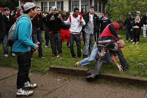 Third place, Student Photographer of the Year - Coty Giannelli / Kent State UniversityOnce the police left to regroup, fights started breaking out again. The fights were vicious some involved multiple people attacking one person.