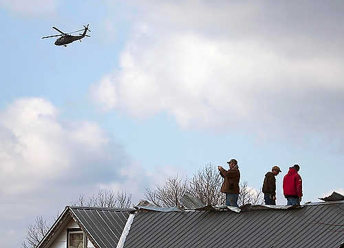 Third place, Student Photographer of the Year - Coty Giannelli / Kent State UniversityCommunity members stand on the roof of one of the few buildings left standing in Marysville, Indiana surveying the damage as a helicopter flies over delivering supplies to workers.