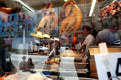 First place, Student Photographer of the Year - Meg Roussos / Ohio University A woman looks in and passes by New Golden Daisy, a quick in and out Chinese restaurant, in Chinatown district of San Francisco.