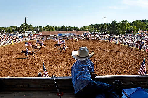 Award of Excellence, Student Photographer of the Year - Meg Vogel / Ohio UniversitySam Morehead, 6, watches the Rodeo City Riders drill team perform at the 54th Annual Mid-Western Rodeo at Hoffmann Memorial Park in Manawa, Wisconsin.