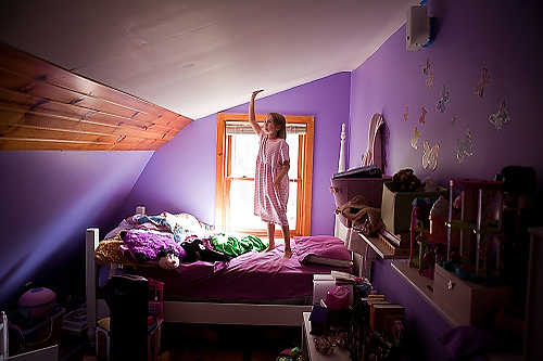 Award of Excellence, Student Photographer of the Year - Meg Vogel / Ohio UniversityKaela Ricket, 8, stands on her bed in her room where the walls were just freshly painted lavendar. Kaela has lived at the Susan B. Anthony Womyn's Land Trust, the women's intentional community in Athens, Ohio, for the past four months with her moms Allison and Angela. 