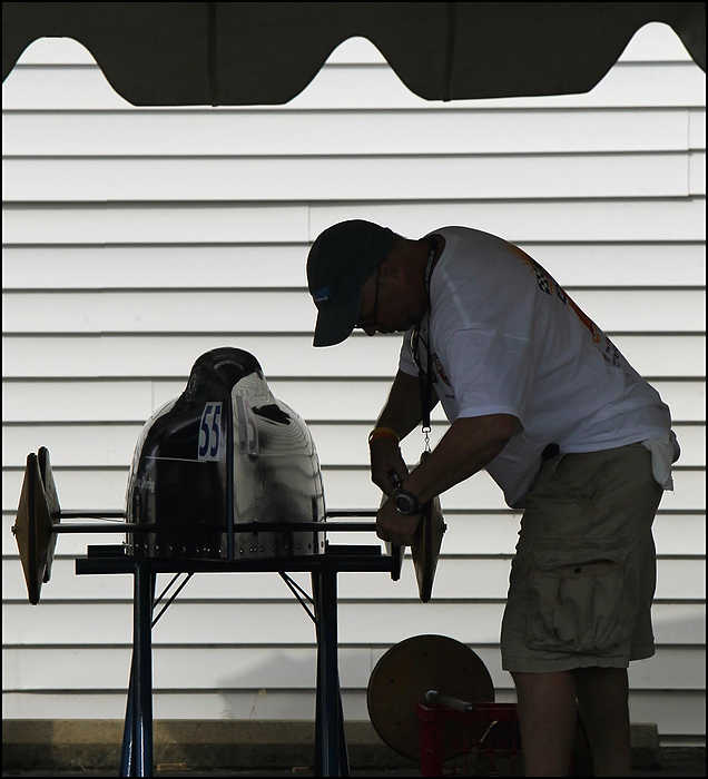 First place, Sports Picture Story - Ed Suba, Jr. / Akron Beacon JournalBob Barnes, assistant director of the Arlington, Massachusetts Soap Box Derby, helps re-calibrate the steering wheel of Arlington racer, Miller Conrad, before his heat in the Masters division at the 75th annual FirstEnergy All-American Soap Box Derby at Derby Downs.