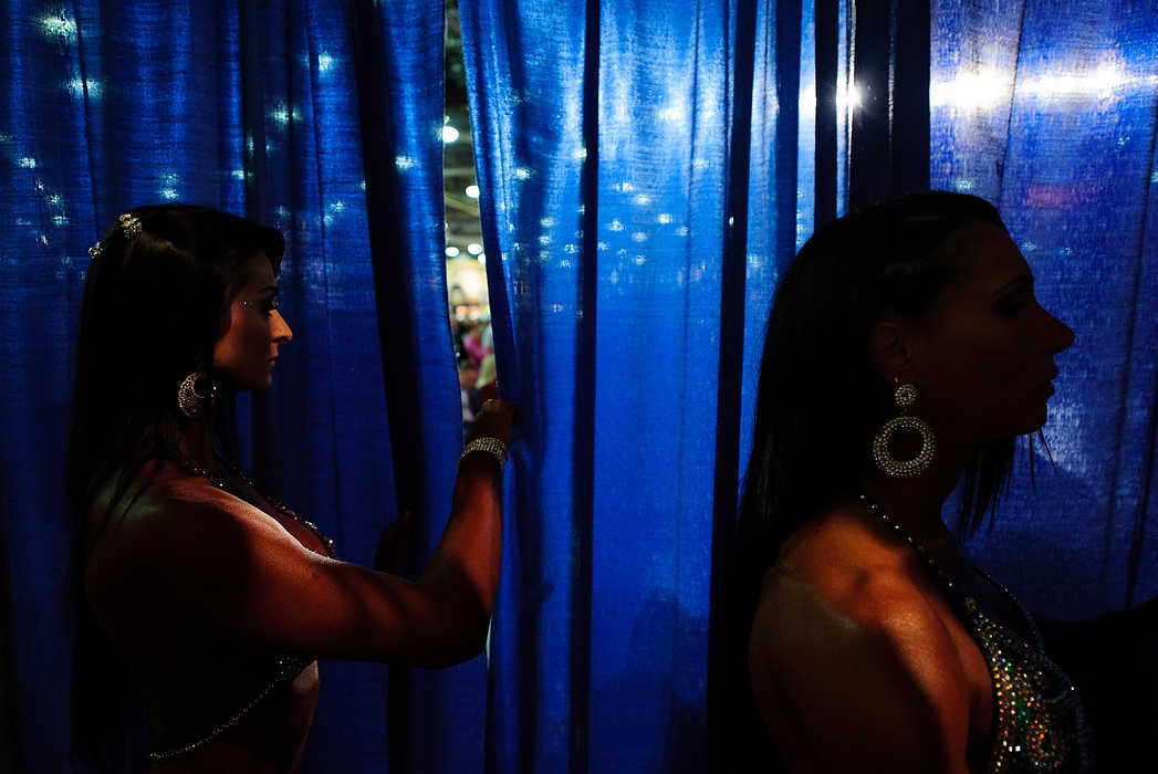 Third place, Sports Picture Story - Joel Hawksley / Ohio UniversityCompetitors in the women's amateur figure finals wait their turn backstage at the Arnold Sports Festival in Columbus.