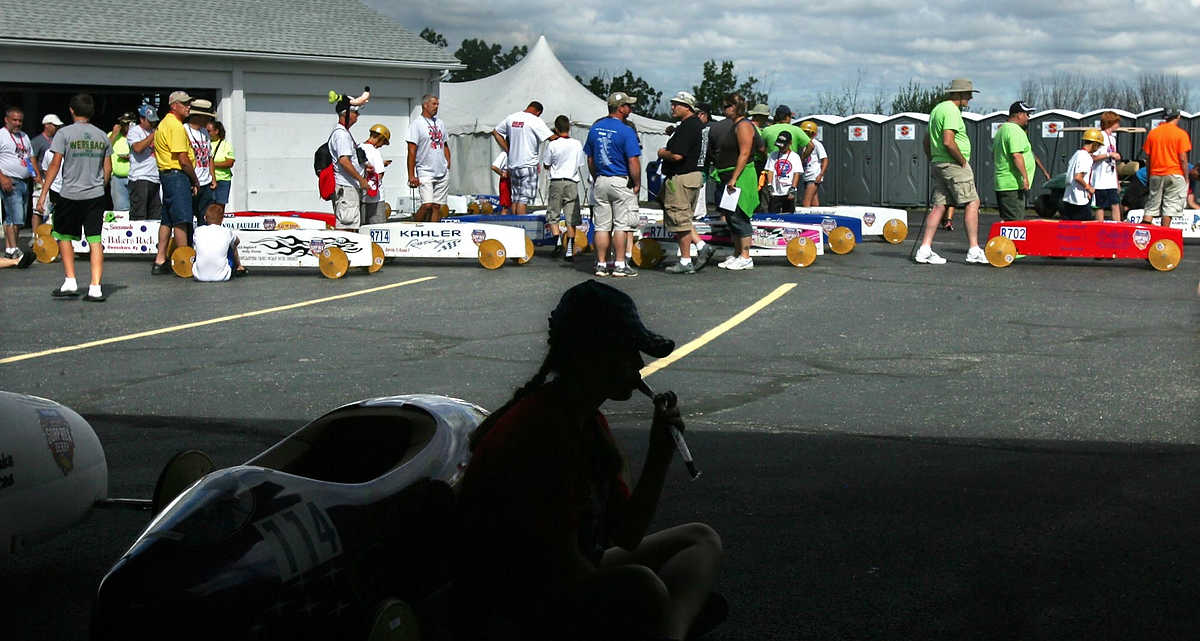 First place, Sports Picture Story - Ed Suba, Jr. / Akron Beacon Journal14-year-old Carly Stead from Bucks County, Pennsylvania, enjoys a popsicle while waiting to run in her heat of the Local Superstock division during the 75th annual FirstEnergy All-American Soap Box Derby at Derby Downs.