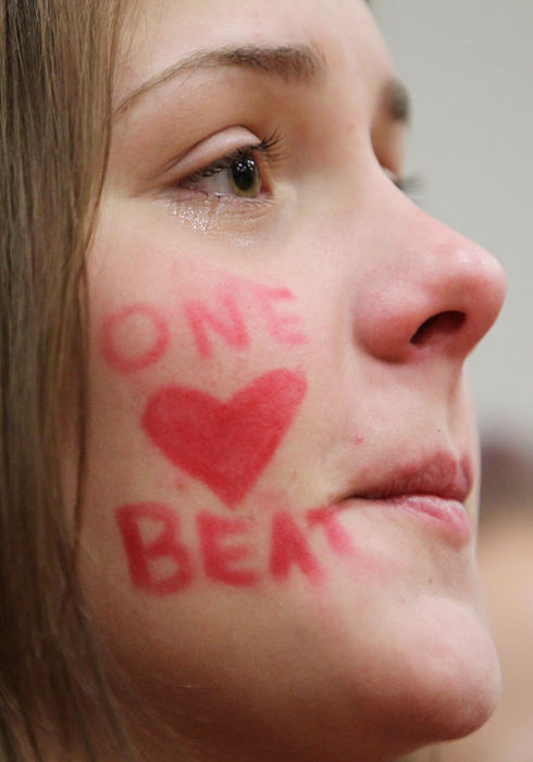 First place, Team Picture Story - John Kuntz / The Plain DealerMaggie Williams, a Chardon High School senior, watches as the school's boys basketball team is introduced.  The community had adopted the slogan "One Heart Beat" to show solidarity.  (John Kuntz/The Plain Dealer)