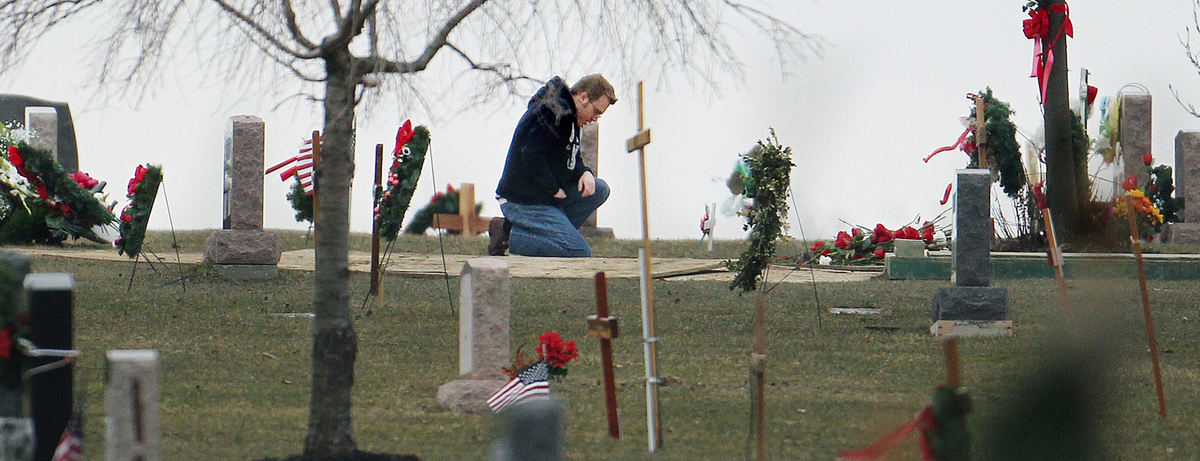 First place, Team Picture Story - John Kuntz / The Plain DealerMore than an hour after Daniel Parmertor was buried at All Souls Cemetery, a young man kneels at the freshly dug grave.  (John Kuntz / The Plain Dealer)